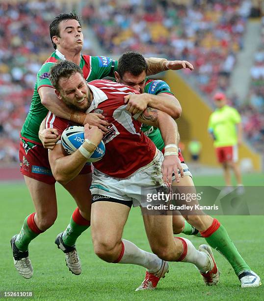 Paul Ivan of the Dolphins is tackled during the Intrust Super Cup Grand Final match between the Wynnum Manly Seagulls and the Redcliffe Dolphins at...