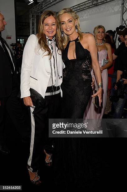 Eva Cavalli and Sharon Stone attend the amfAR Milano 2012 Cocktail reception during Milan Fashion Week at La Permanente on September 22, 2012 in...