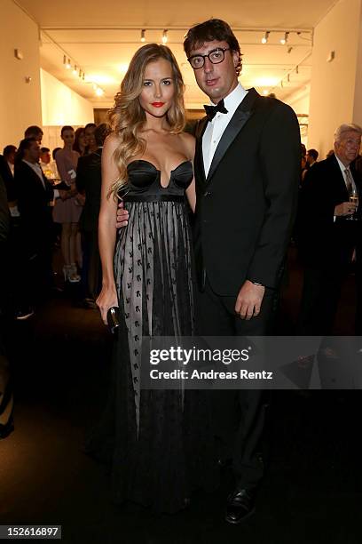 Natalia Borges and Lorenzo Tonetti attend the amfAR Milano 2012 Cocktail reception during Milan Fashion Week at La Permanente on September 22, 2012...