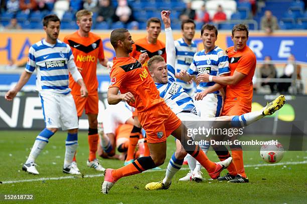 Andre Hoffmann of Duisburg misses a chance at goal under the pressure of Mounir Chaftar of Bochum during the Second Bundesliga match between MSV...