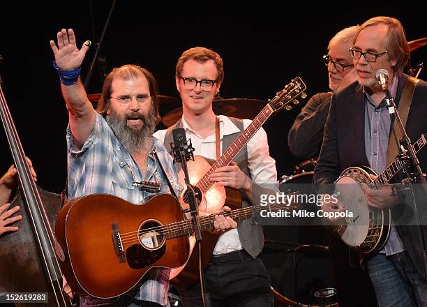 Singer/songwriter Steve Earle and members of the Tony Trischka Band perform during the 'This Land Is Your Land' Woody Guthrie At 100 Concert as part...
