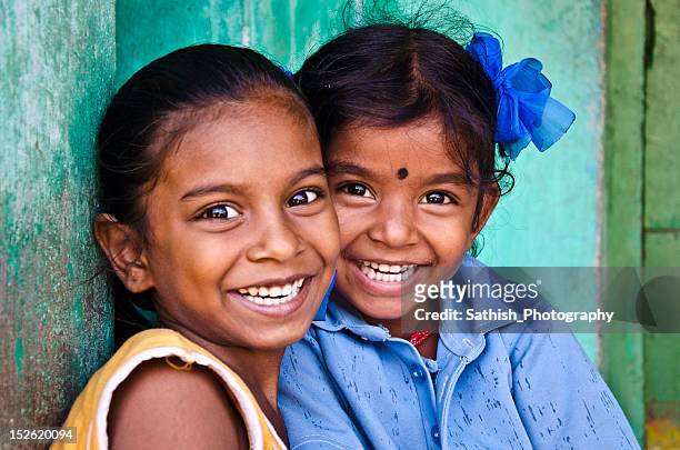 sisters smiling - indian child ストックフォトと画像