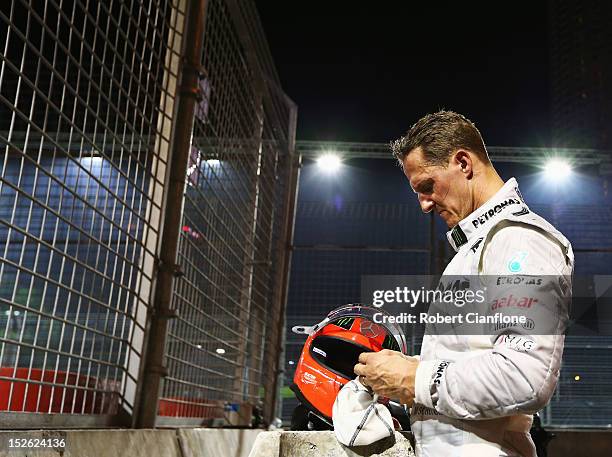 Michael Schumacher of Germany and Mercedes GP retires early after crashing into the back of Jean-Eric Vergne of France and Scuderia Toro Rosso during...