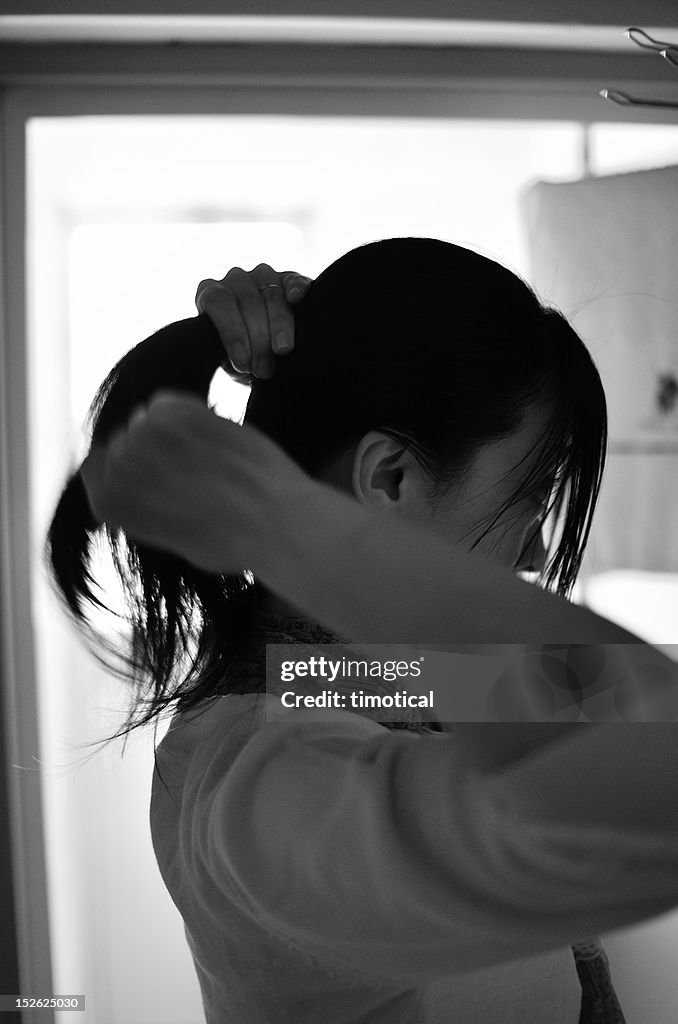 Japanese woman brushing her back hair