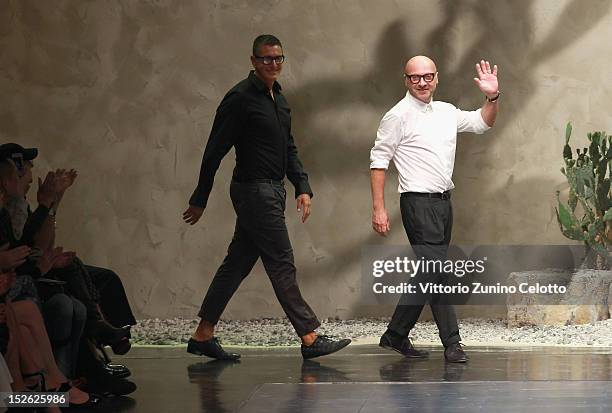 Designers Stefano Gabbana and Domenico Dolce acknowledge the applause of the public after the Dolce & Gabbana Spring/Summer 2013 fashion show as part...