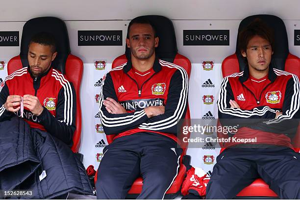 Sidney Sam, Renato Augusto and Hajime Hosogai of Leverkusen sit on the bench during the Bundesliga match between Bayer 04 Leverkusen and Borussia...