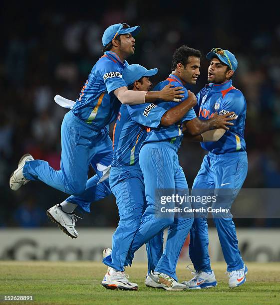 Irfan Pathan of India celebrates with teammates after dismissing Alex Hales of England during the ICC World Twenty20 2012 Group A match between...