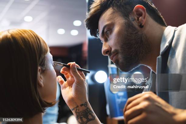 makeup artist working applying the eyeshadow - hair color saloon stock pictures, royalty-free photos & images
