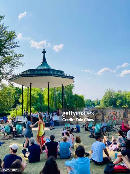 large group of people enjoying live music at the regent's park bandstand in london - bandstand stock pictures, royalty-free photos & images