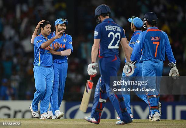 Piyush Chawla of India celebrates with teammates after dismissing Craig Kieswetter of England during the ICC World Twenty20 2012 Group A match...