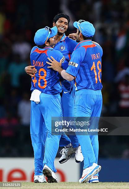 Ashok Dinda of India is congratulated by Suresh Raina and Virat Kohli, after Stuart Broad was caught by Gautam Gambhir during the ICC World Twenty20...