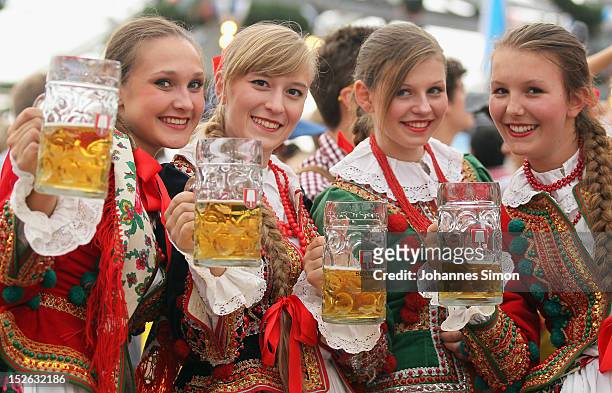 Polish girls, dressed with traditional Polish costume enjoy drinking beer after participating in the opening parade during day 2 of Oktoberfest beer...