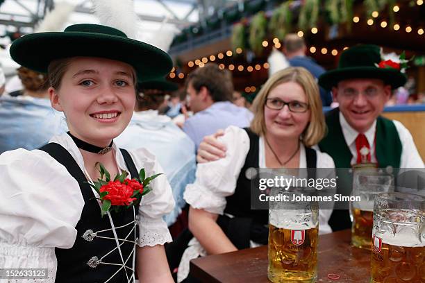 Participants of the opening parade, dressed with traditional Bavarian costume enjoy drinking beer at Schottenhamel beer tent during day 2 of...