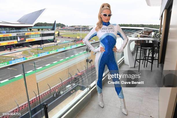 Paris Hilton enjoys the Silverstone Circuit track views from the Hilton Garden Inn Silverstone rooftop at the hotel's opening party on the eve of the...