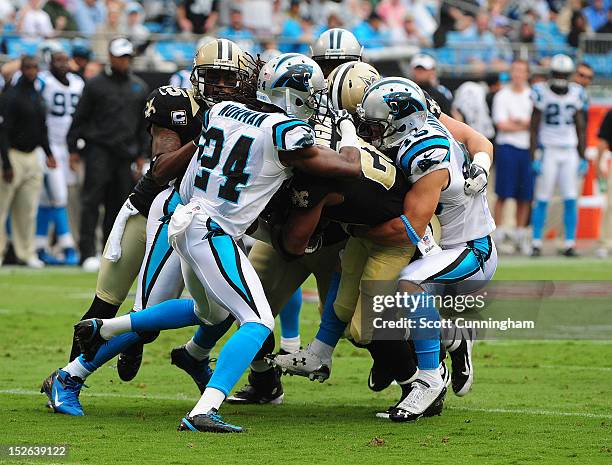 Mark Ingram of the New Orleans Saints is tackled by Haruki Nakamura and Josh Norman of the Carolina Panthers at Bank of America Stadium on September...