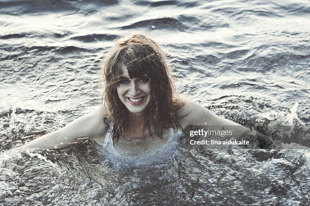 Young woman swimming in lake