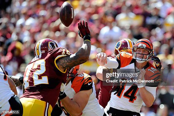 Andy Dalton of the Cincinnati Bengals is hit as he throws an interception caught by Rob Jackson of the Washington Redskins for a touchdown in the...