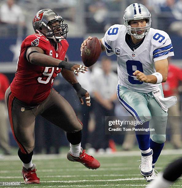 Tony Romo of the Dallas Cowboys scrambles with the ball against Gerald McCoy of the Tampa Bay Buccaneers at Cowboys Stadium on September 23, 2012 in...