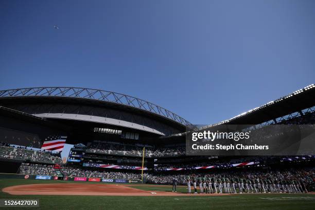 The American League Futures and the National League Futures stand for the national anthem ahead of the SiriusXM All-Star Futures Game at T-Mobile...