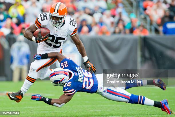 Running back Chris Ogbonnaya of the Cleveland Browns jumps over defensive back Justin Rogers of the Buffalo Bills during the first half at Cleveland...