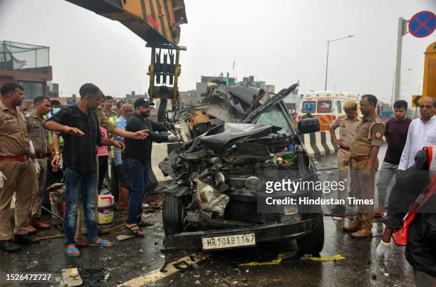 Ghaziabad Police and and others Person near the wreckage of a car after a head-on collision with a bus on in which Six members of a family died and...