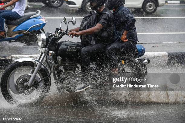 Commuters moves through a water logged street after heavy rains lashes out the city at ITO Bahadur shah zafar on July 10, 2023 in New Delhi, India....