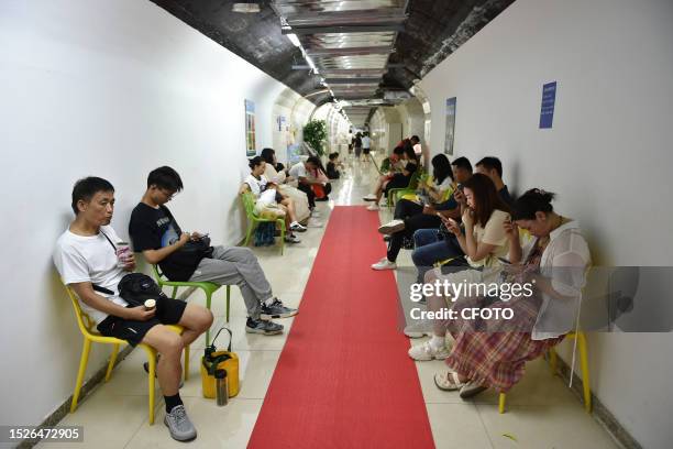 Citizens cool off in an air-raid shelter in Nanjing, East China's Jiangsu province, July 12, 2023. On the same day, Nanjing meteorological...