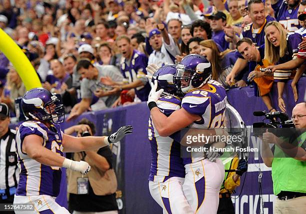 Brandon Fusco, Matt Kalil and Kyle Rudolph of the Minnesota Vikings celebrate a touchdown by Rudolph during the fourth quarter of the game against...