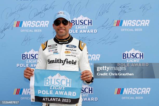 Aric Almirola, driver of the Smithfield/IHOP Ford, poses for photos after winning the pole award during qualifying for the NASCAR Cup Series Quaker...