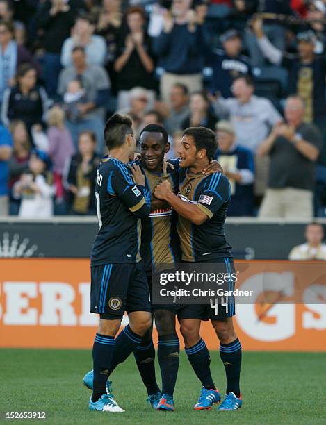 Amobi Okugo of the Philadelphia Union is congratulated by teammates Michael Farfan and Danny Cruz after scoring a goal against the Houston Dynamo at...