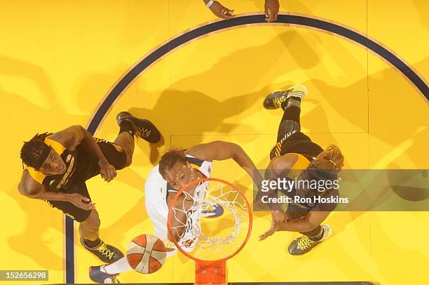 Tamika Catchings of the Indiana Fever battles Amber Holt and Roneeka Hodges of the Tulsa Shock for a rebound at Banker's Life Fieldhouse on September...