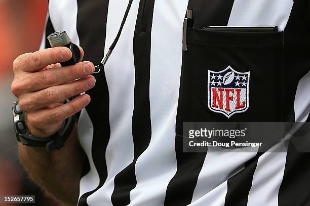 Detail of the uniform and whistle of an NFL referee as he oversees the action between the Houston Texans and the Denver Broncos at Sports Authority...
