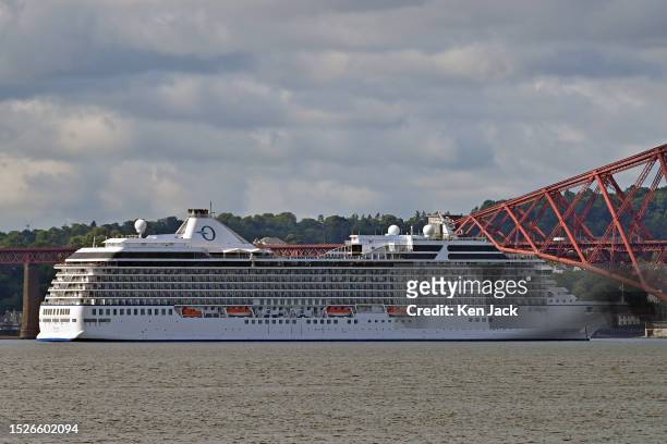 The Oceania cruise ship Riviera at anchor off the Forth Bridge, with the UK cruising season in full swing, on July 12, 2023 in Dalgety Bay, Scotland.