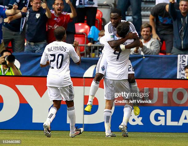 Goal scorer Alain Rochat of the Vancouver Whitecaps FC is congratulated by Darren Mattocks while Dane Richards approaches against the Colorado Rapids...