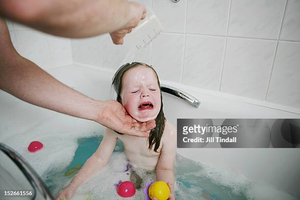 young girl having a hairwash in the bathtub - woman bath tub wet hair stock pictures, royalty-free photos & images