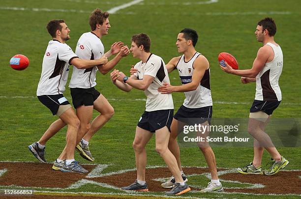 Luke Hodge, Grant Birchall, Liam Shiels, Shane Savage and Brent Guerra of the Hawks compete for the ball during a Hawthorn Hawks training session at...