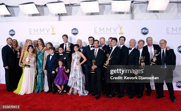 Cast, writers and producers of "Modern Family" pose in the press room during the 64th Annual Primetime Emmy Awards at Nokia Theatre L.A. Live on...