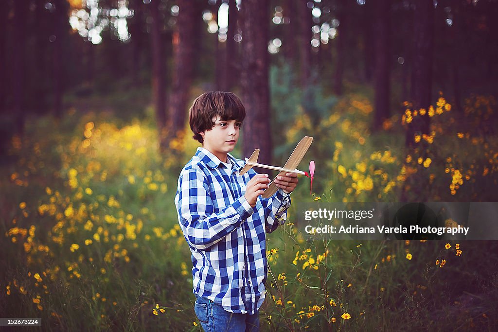 Boy holding toy airplane