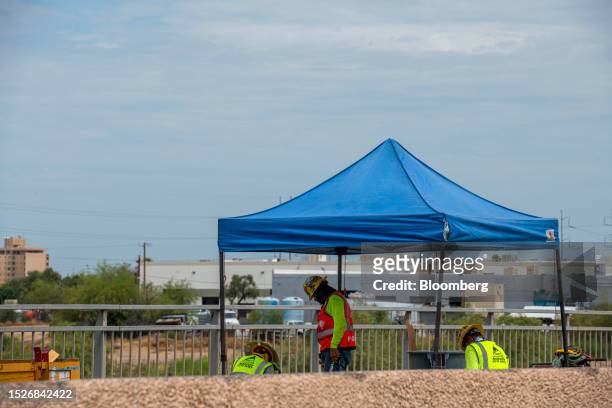 Construction workers under an awning during a heatwave in Phoenix, Arizona, US, on Tuesday, July 11, 2023. A massive heat wave will build in the...