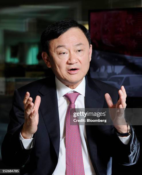 Thaksin Shinawatra, former prime minister of Thailand, gestures as he speaks during an interview in Singapore, on Monday, Sept. 24, 2012. Thaksin...