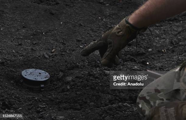 Ukrainian army's 35th Marine Brigade members conduct mine clearance work at a field in Donetsk, Ukraine on July 11, 2023. The Engineer Group of the...