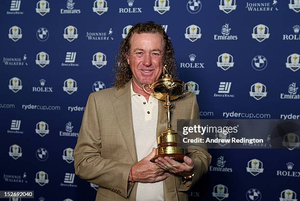 Team Vice Captain Miguel Angel Jimenez poses with the Ryder Cup as the Europe team depart for the Ryder Cup from Heathrow Airport on September 24,...