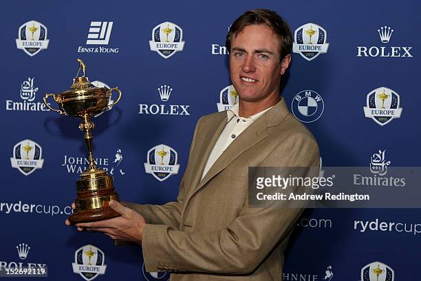 Nicolas Colsaerts of Belgium poses with the Ryder cup as the Europe team depart for the Ryder Cup from Heathrow Airport on September 24, 2012 in...