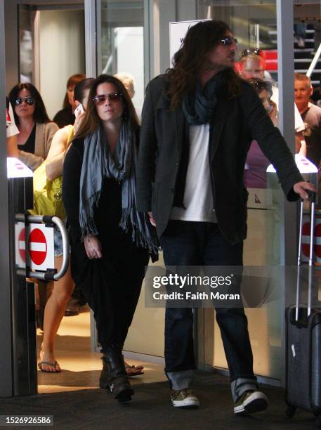 Holly Marie Combs and Josh Cocktail arrive at Perth Airport on March 27, 2014 in Perth, Australia.