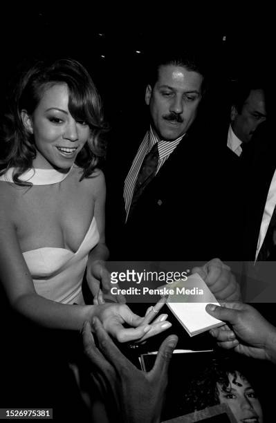 Mariah Carey and guest attend Sony Music's 1996 Grammy Awards afterparty in Los Angeles, California, on February 28, 1996.