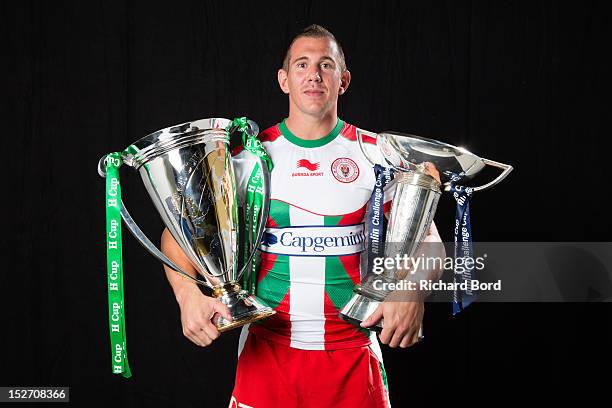 Imanol Harinordoquy, captain of Biarritz Olympique PB, poses with the Heineken Cup and the Amlin Challenge Cup during the Heineken Cup Launch at...