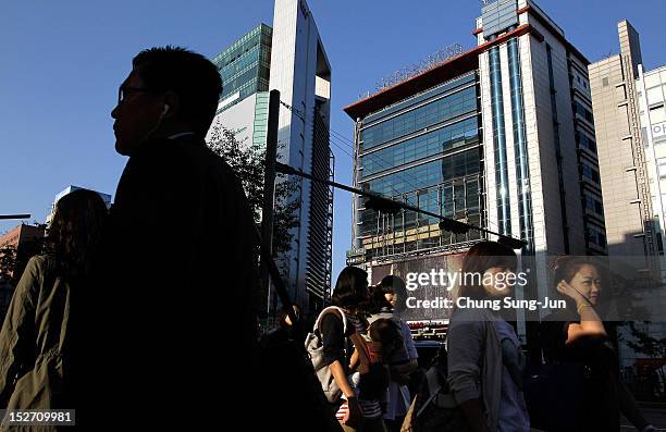 People walk at the shopping district in Seoul's Gangnam District on September 24, 2012 in Seoul, South Korea. The Gangnam District is the wealthiest...