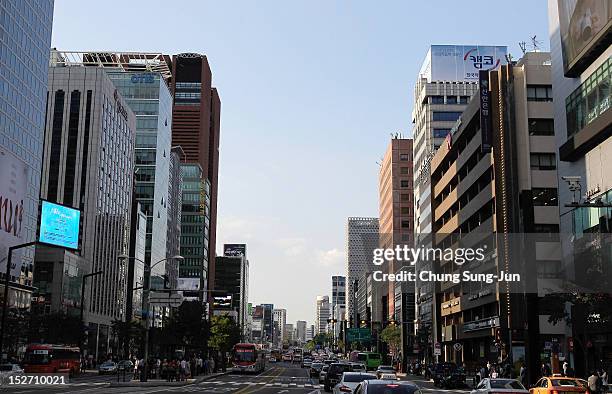 People walk at the shopping district in Seoul's Gangnam District on September 24, 2012 in Seoul, South Korea. The Gangnam District is the wealthiest...