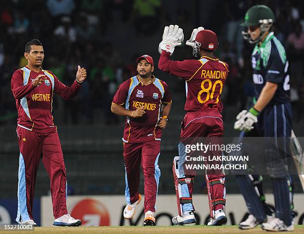 West Indies cricketer Sunil Narine celebrates with his teammates after he dismissed Ireland cricketer Ed Joyce during the ICC Twenty20 Cricket World...