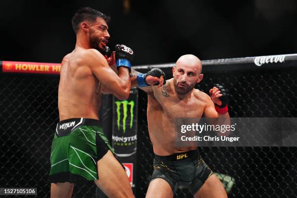 Alexander Volkanovski of Australia punches Yair Rodriguez of Mexico in the UFC featherweight championship fight during the UFC 290 event at T-Mobile...